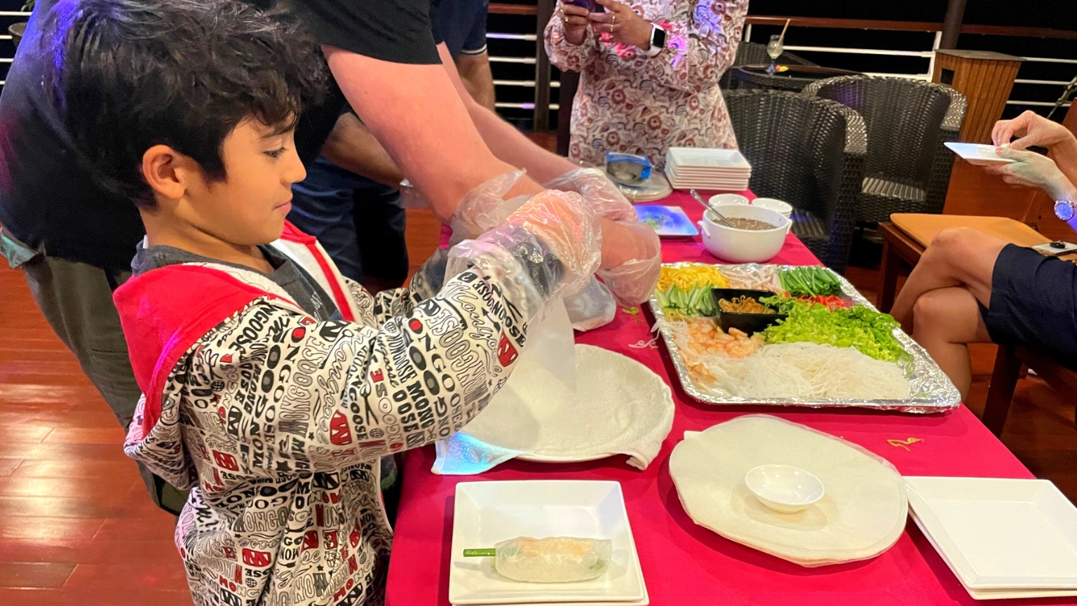 Little guest enjoying a hands-on Vietnamese cooking class